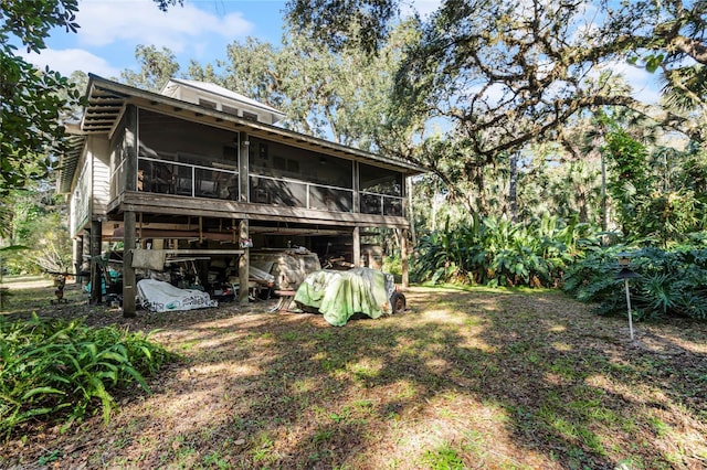 back of house featuring a sunroom