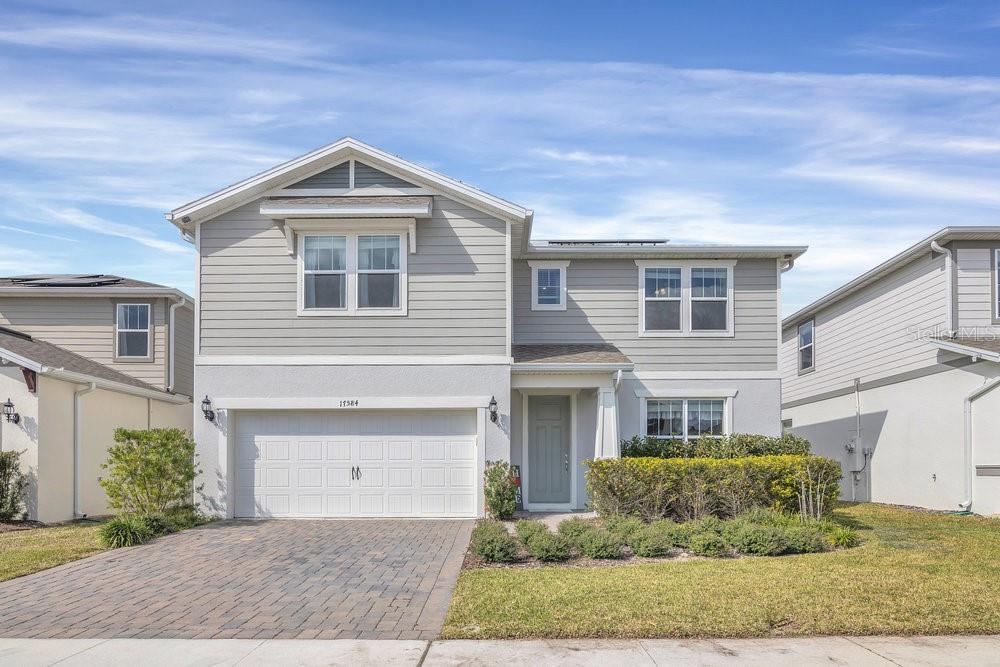 17584 Saw Palmetto Ave, Clermont, FL 34714 - view of front facade featuring a garage and a front lawn