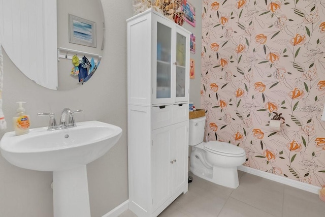 bathroom featuring sink, tile patterned floors, and toilet