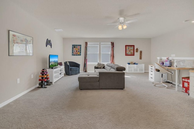 living room with ceiling fan and carpet