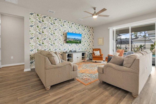 living room featuring hardwood / wood-style floors and ceiling fan