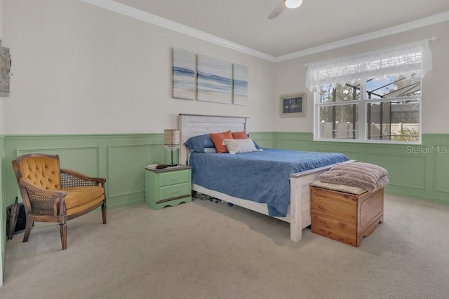 bedroom featuring ceiling fan, ornamental molding, and carpet floors