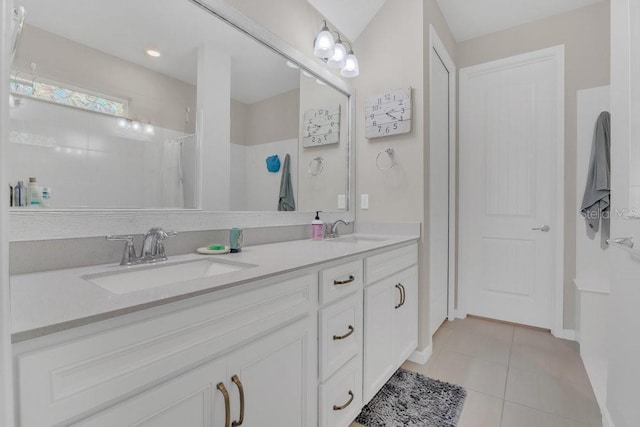 bathroom with a shower, tile patterned floors, and vanity