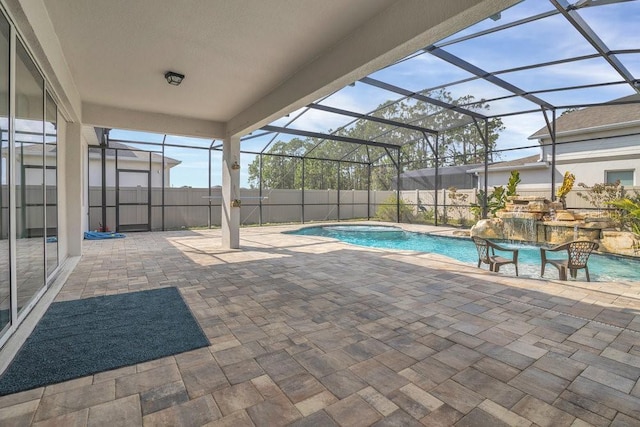 view of swimming pool with an in ground hot tub, a lanai, and a patio