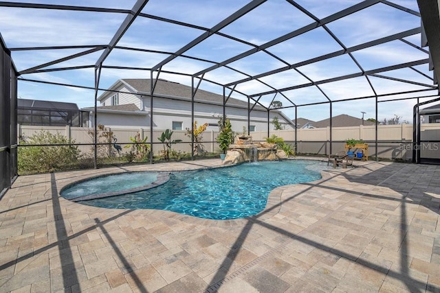 view of swimming pool with an in ground hot tub, a patio, pool water feature, and glass enclosure