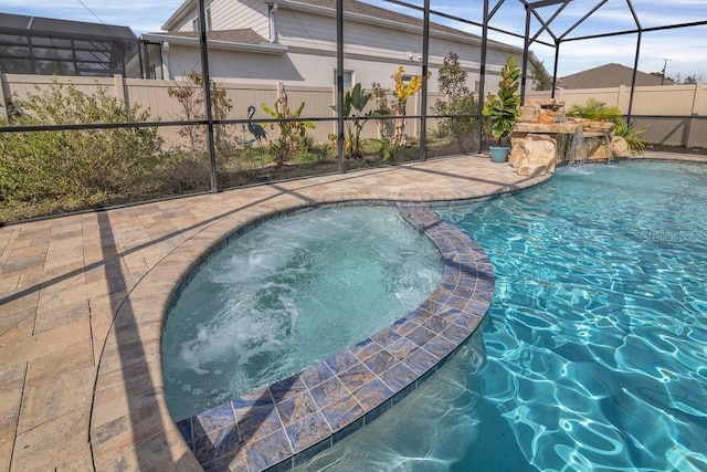 view of pool featuring a lanai, a patio area, and pool water feature