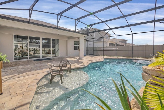 view of swimming pool with a patio and glass enclosure