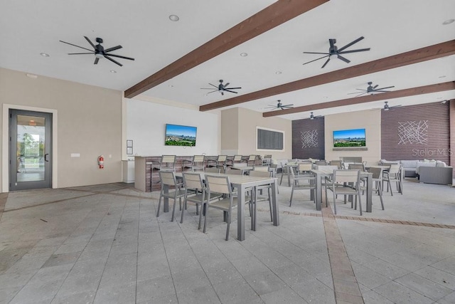 dining space with beamed ceiling