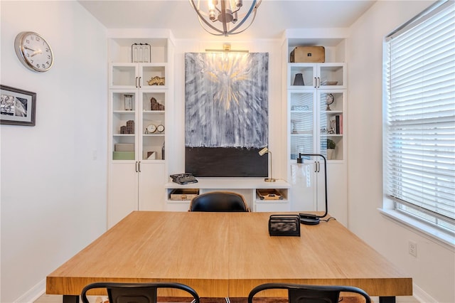 office area with an inviting chandelier