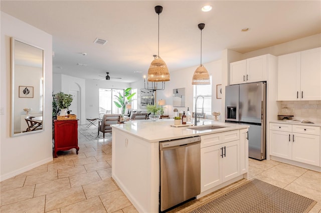 kitchen featuring a sink, visible vents, white cabinets, appliances with stainless steel finishes, and backsplash