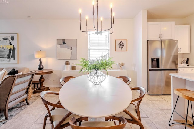 dining room with light tile patterned floors, baseboards, and an inviting chandelier