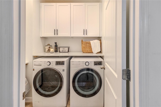 laundry area featuring independent washer and dryer and cabinet space