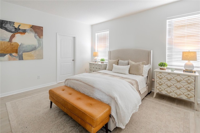 bedroom featuring light wood-type flooring and baseboards