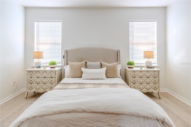 bedroom with baseboards and light wood-style floors