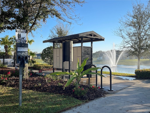 view of community with a water view and mail area