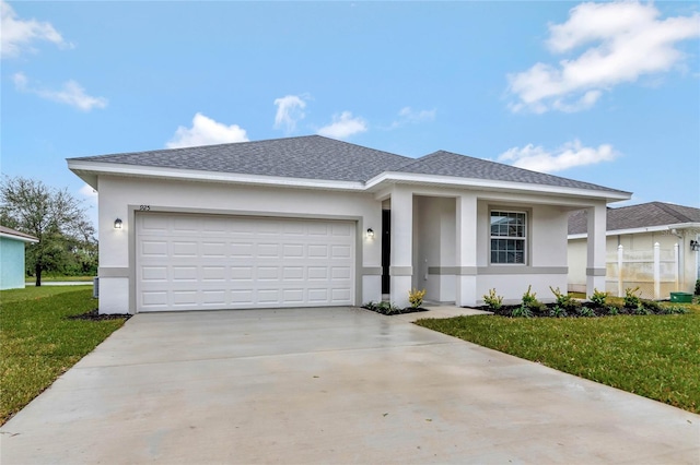 view of front of home featuring a garage and a front lawn