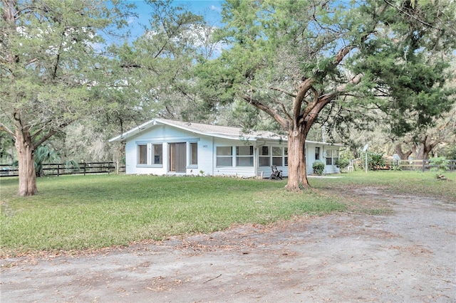 ranch-style home with a front yard