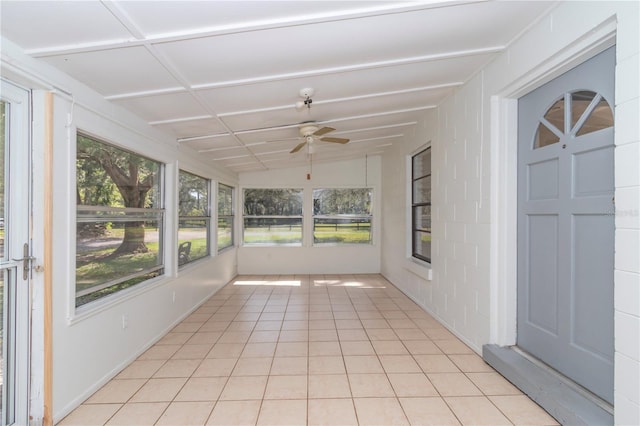 unfurnished sunroom featuring vaulted ceiling and ceiling fan