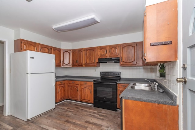 kitchen with white refrigerator, dark hardwood / wood-style flooring, black range with electric cooktop, decorative backsplash, and sink