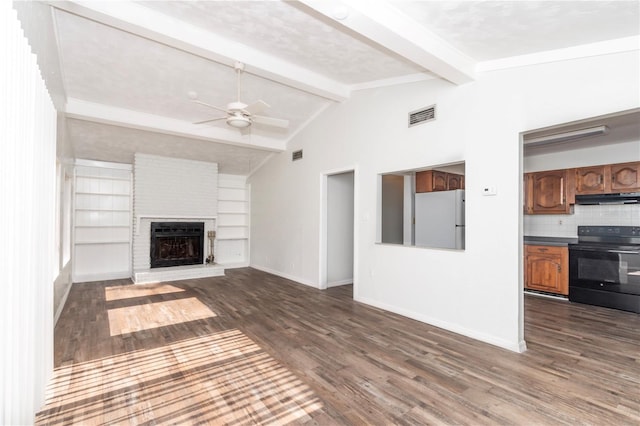 unfurnished living room with ceiling fan, built in features, dark wood-type flooring, lofted ceiling with beams, and a fireplace