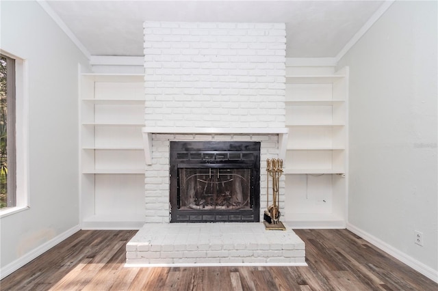 interior details featuring a brick fireplace, hardwood / wood-style floors, and ornamental molding