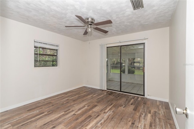 spare room featuring ceiling fan, a textured ceiling, and dark hardwood / wood-style floors