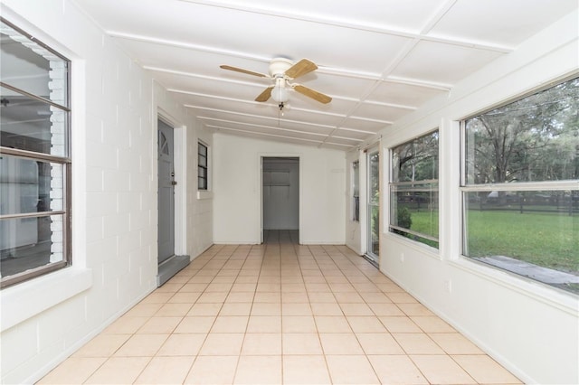 unfurnished sunroom with vaulted ceiling and ceiling fan