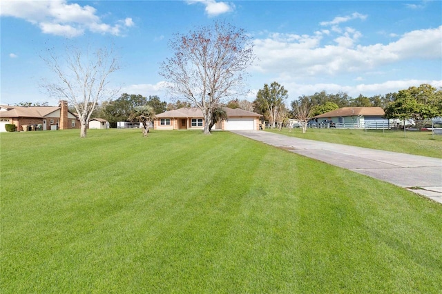 single story home with a garage and a front lawn