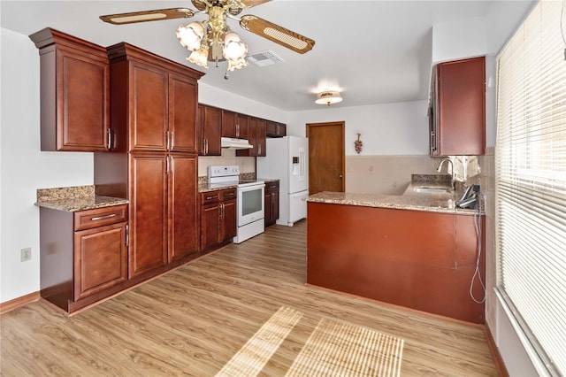 kitchen with white appliances, light stone countertops, sink, light hardwood / wood-style flooring, and ceiling fan