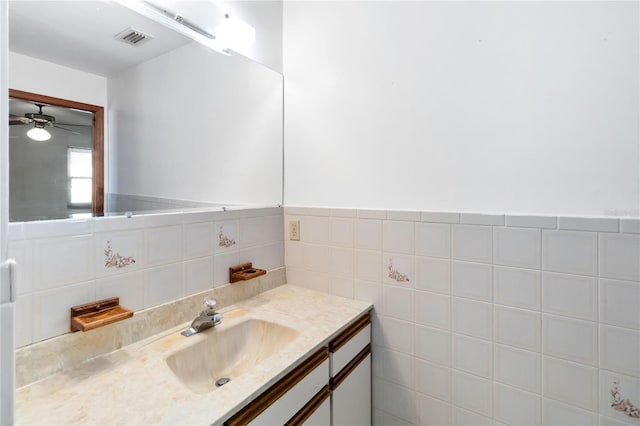 bathroom featuring tile walls and vanity