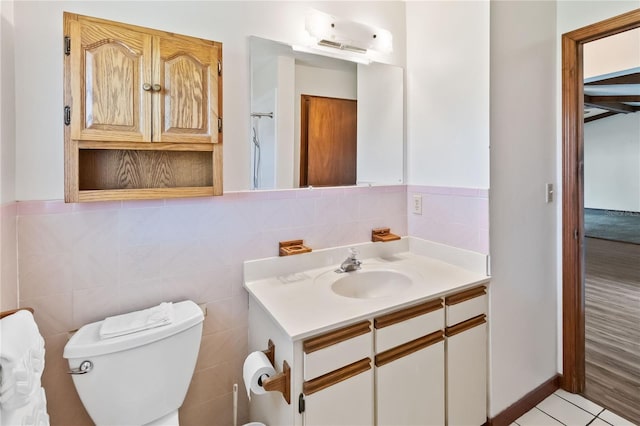 bathroom featuring vanity, toilet, and tile patterned flooring