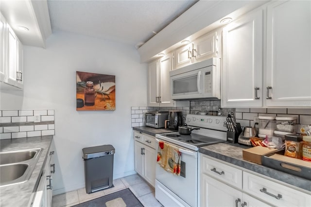 kitchen featuring white cabinetry, white appliances, and light tile patterned flooring