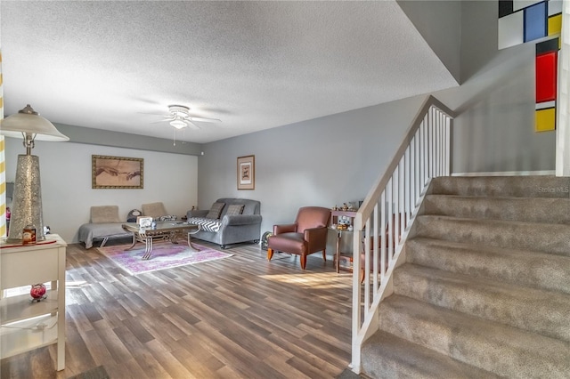 living room with hardwood / wood-style floors, a textured ceiling, and ceiling fan