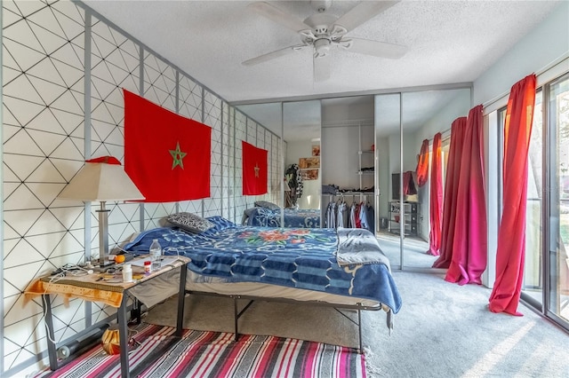 bedroom with a textured ceiling, access to outside, carpet flooring, a closet, and ceiling fan