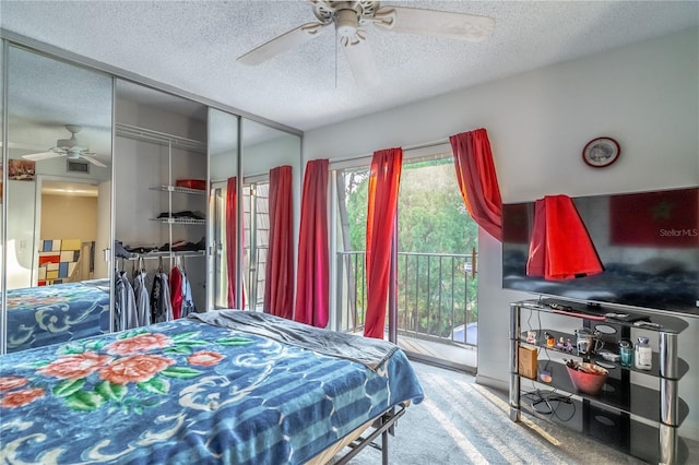 carpeted bedroom with access to exterior, a closet, a textured ceiling, and ceiling fan