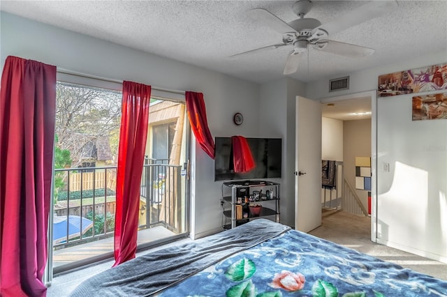 bedroom with ceiling fan, light colored carpet, access to exterior, and a textured ceiling