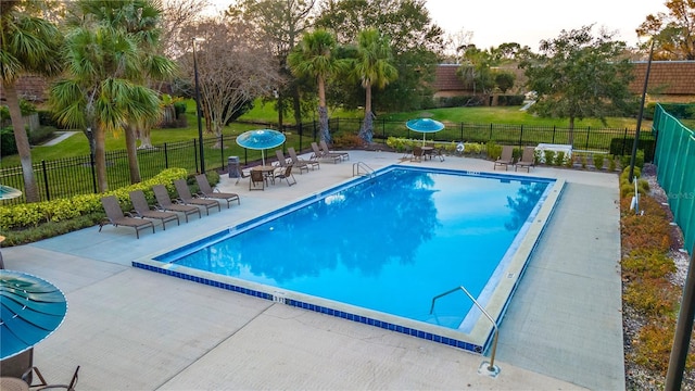 view of swimming pool featuring a patio area