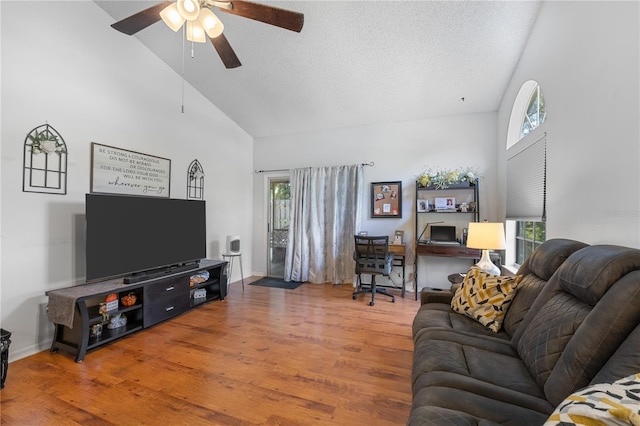 living room featuring high vaulted ceiling, wood-type flooring, and ceiling fan