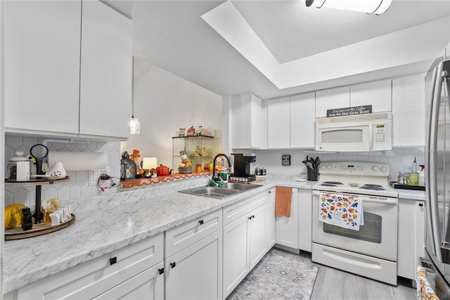 kitchen with white cabinetry, sink, white appliances, and backsplash