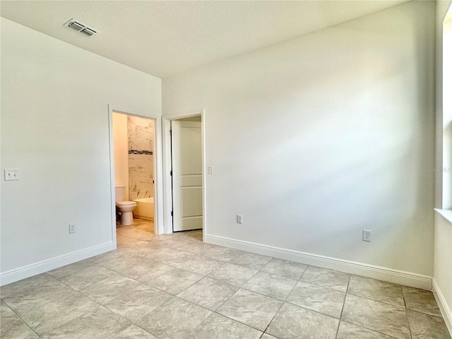 unfurnished bedroom featuring ensuite bathroom