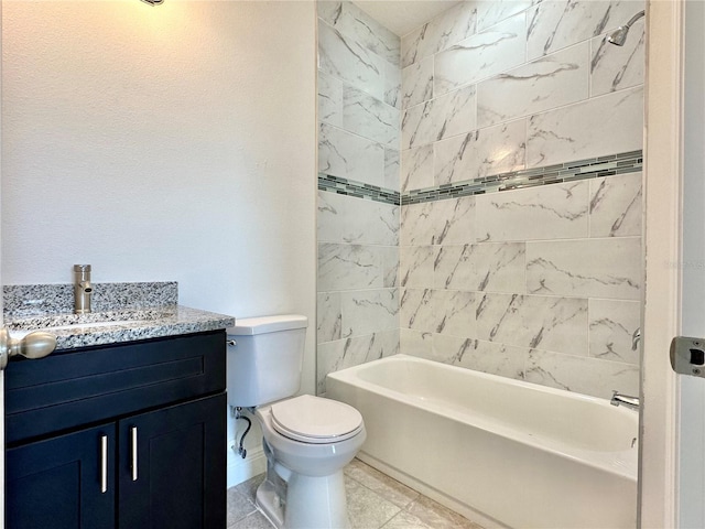 full bathroom with vanity, tile patterned flooring, toilet, and tiled shower / bath