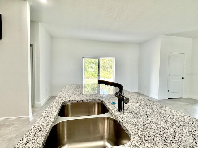 interior details featuring sink and light stone counters