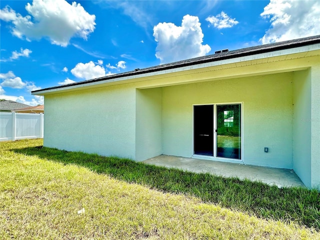 back of house featuring a yard and a patio