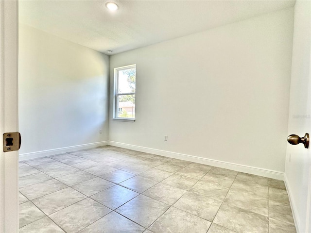 unfurnished room featuring light tile patterned flooring