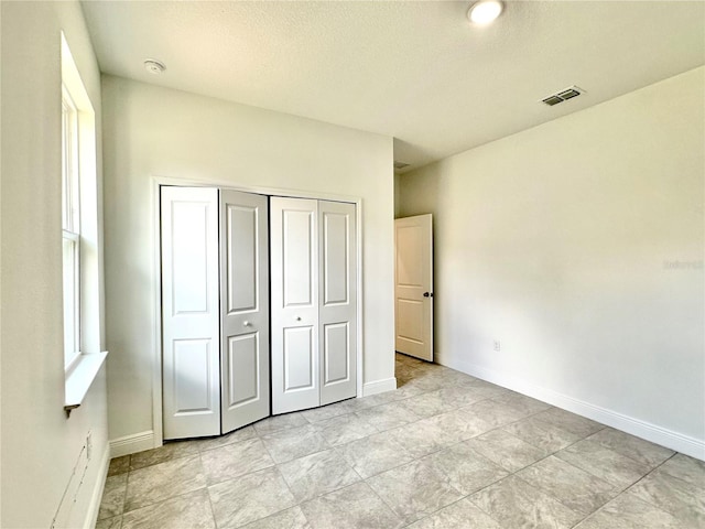 unfurnished bedroom with a closet