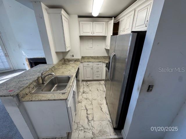 kitchen featuring white cabinetry and kitchen peninsula