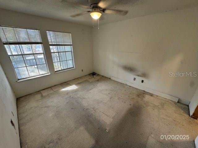 carpeted empty room with ceiling fan