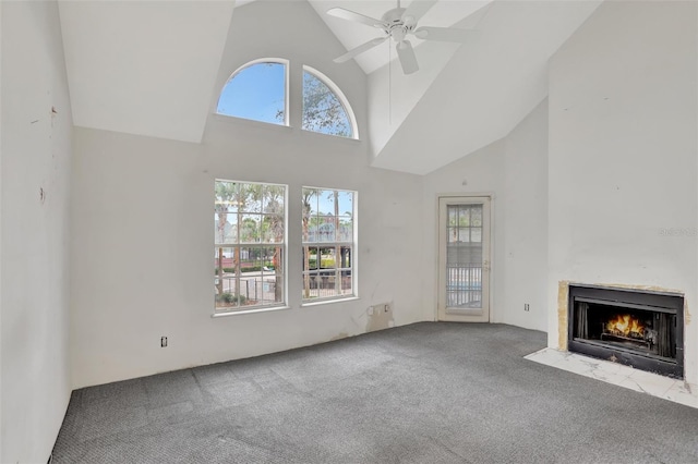 unfurnished living room featuring light carpet, ceiling fan, high vaulted ceiling, and a fireplace with flush hearth