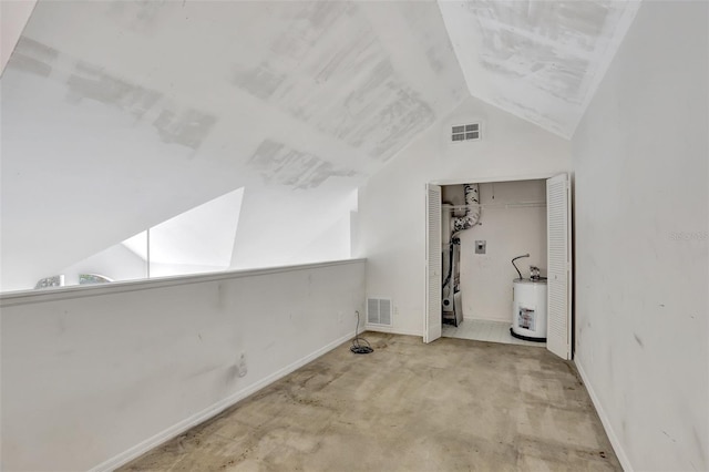 bonus room featuring water heater, vaulted ceiling, visible vents, and baseboards