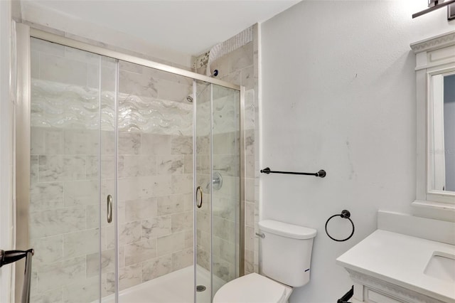 full bath with toilet, a shower stall, and vanity